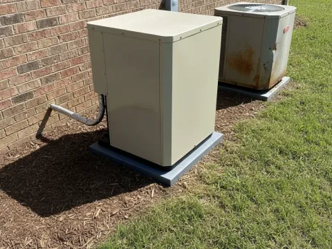 New heat pump condenser installed outside Providence Village home after replacement