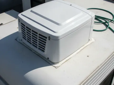 Repaired rooftop RV air conditioner unit sealed and reinstalled in Aubrey